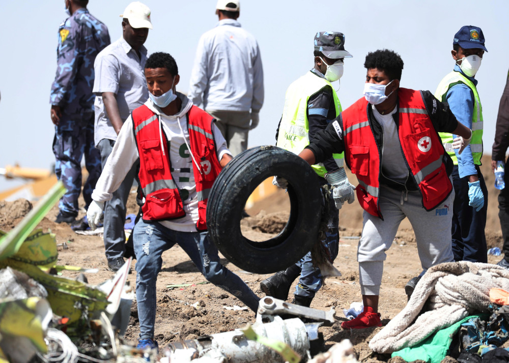 Search workers carry a tyre at the scene of the Ethiopian Airlines Flight ET 302 plane crash, near the town of Bishoftu, southeast of Addis Ababa, Ethiopia March 11, 2019. u00e2u20acu201d Reuters pic  